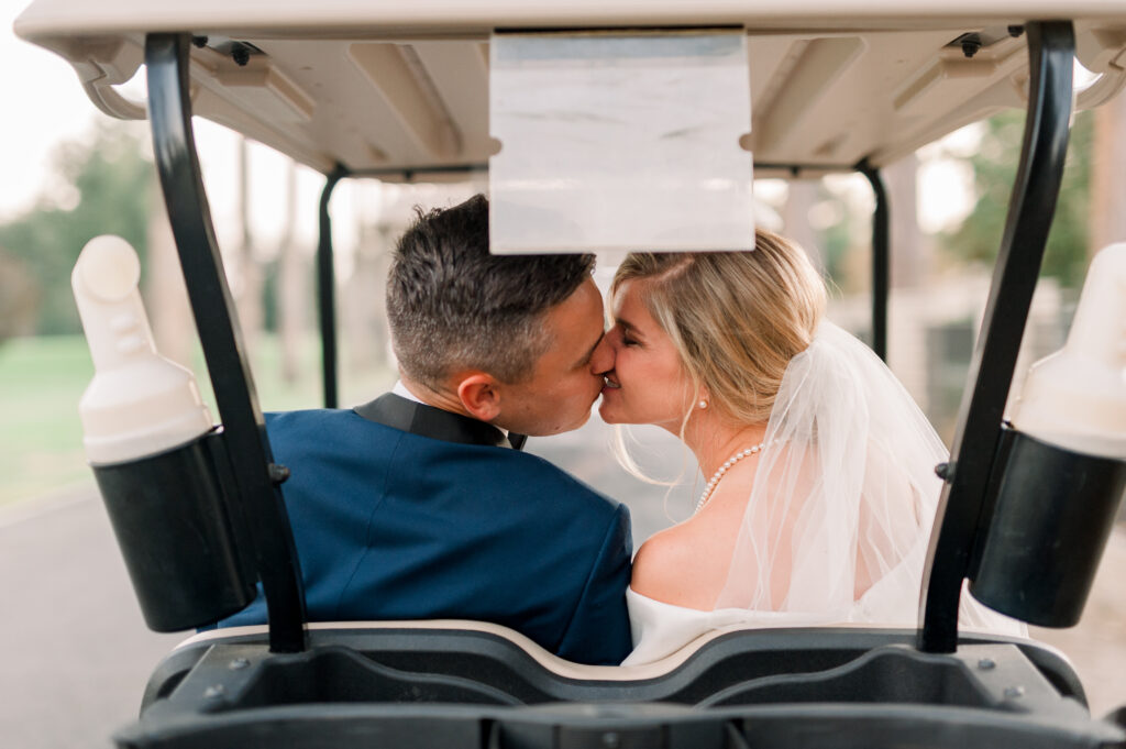 wedding couple kiss in the stockdale country club golf cart
